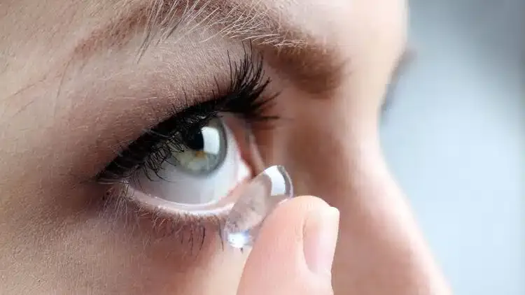 Femme mettant une lentille de contact sur son œil pour corriger sa vision