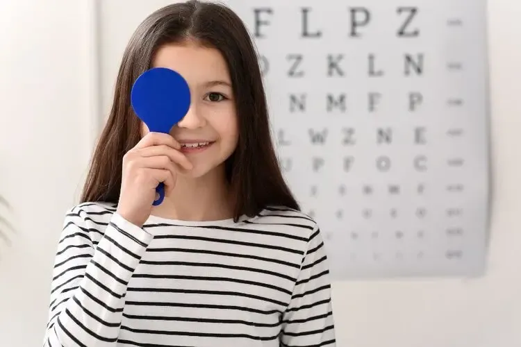 Examen de la vue pour dépistage de l’astigmatisme chez une enfant